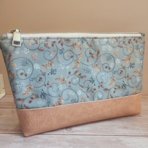 large pouch with white zipper and light faux leather base