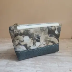 small pouch with white zipper and grey faux leather base